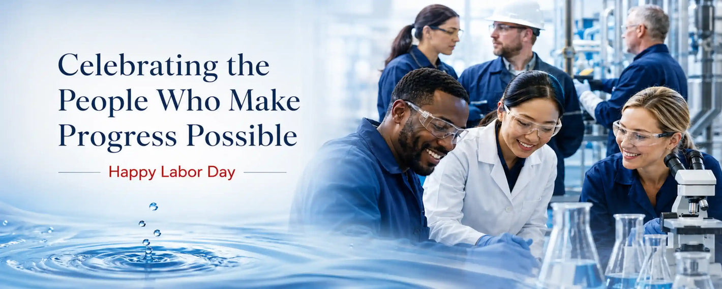 Labor Day promotional banner featuring scientists and engineers in a laboratory setting, with the text 'Celebrating the People Who Make Progress Possible' and 'Happy Labor Day' over a water ripple graphic.
